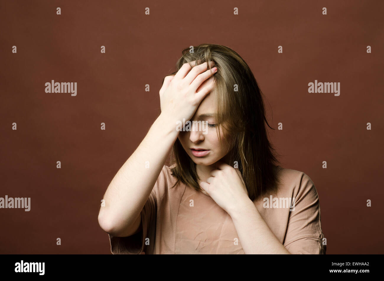 Depressed young woman hand on head Stock Photo