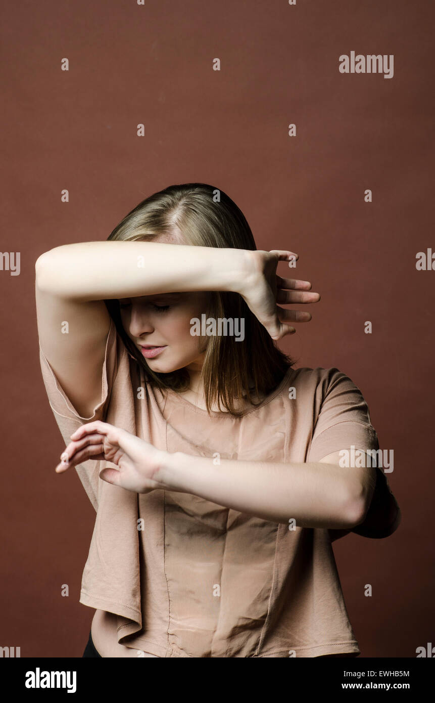 Young woman in danger hiding face with hands Stock Photo