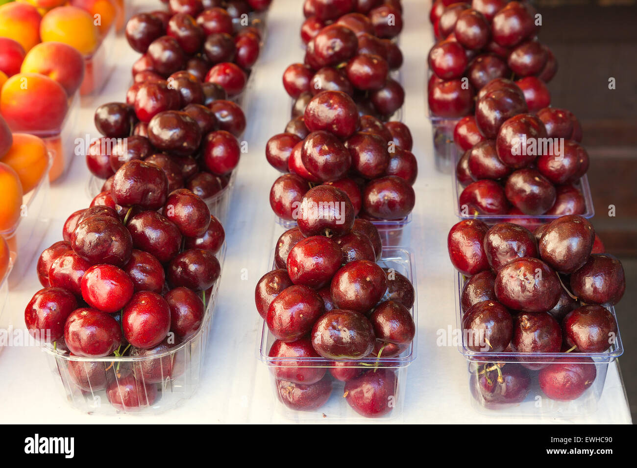 Colorful display of ripe cherries at a food market. Stock Photo