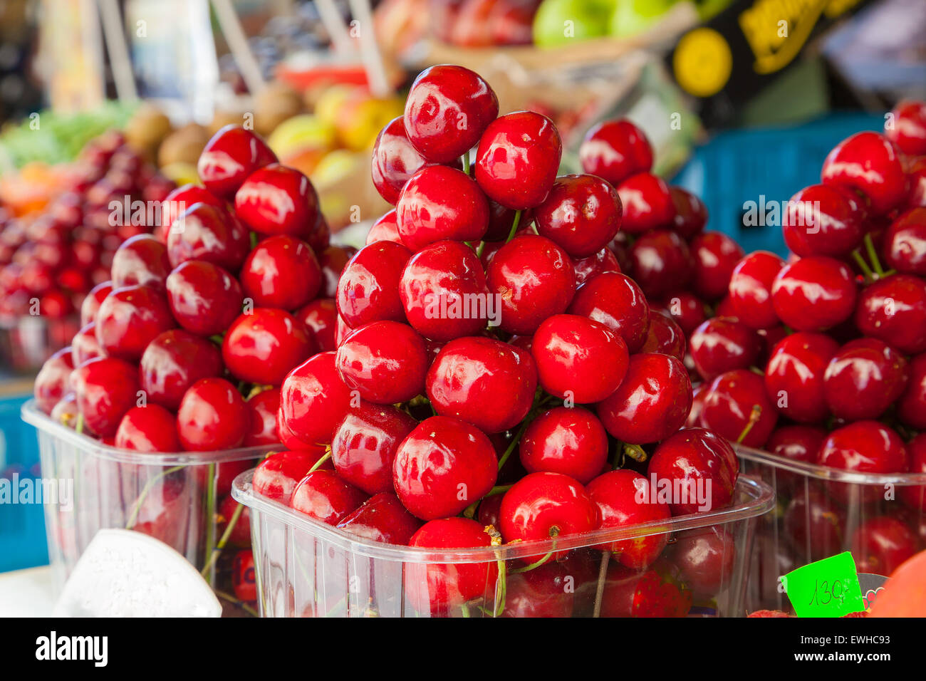 Colorful display of ripe cherries at a food market. Stock Photo