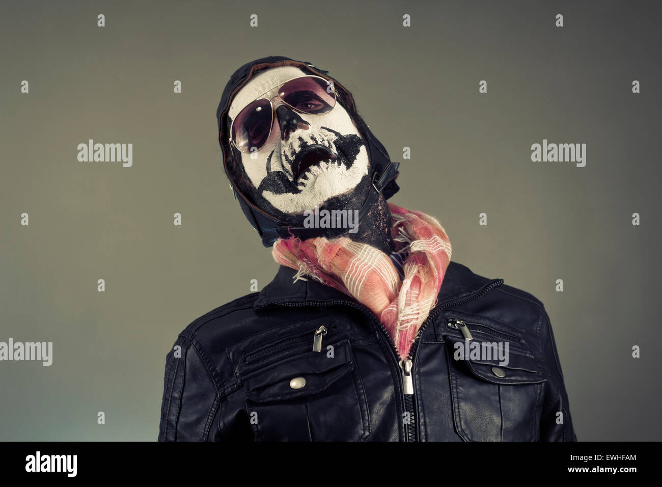 Crying aviator with face painted as human skull Stock Photo