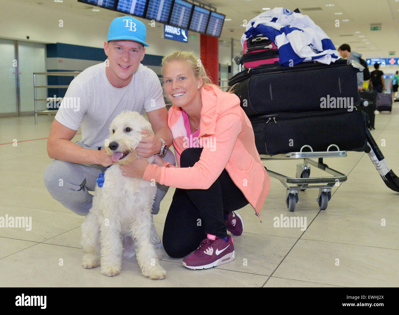 Prague, Czech Republic. 26th June, 2015. Hockey Stanley Cup finalist Ondrej  Palat of Tampa Bay arrives with his partner Barbora Bartikova and dog Snowy  in Prague, Czech Republic, June 26, 2015. ©