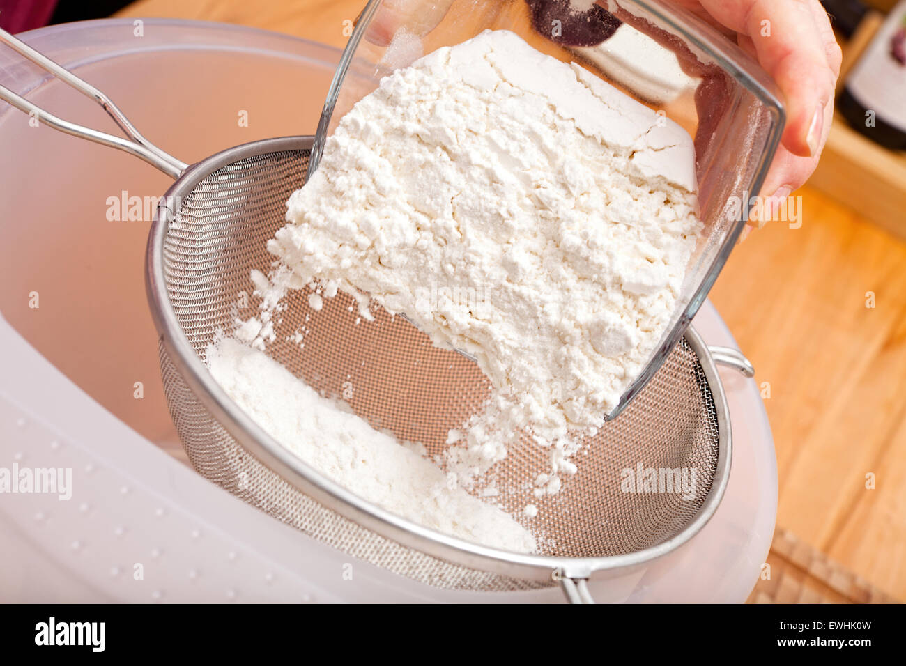 Put flour of glass bowl through a flour sieve to make a cookie dough