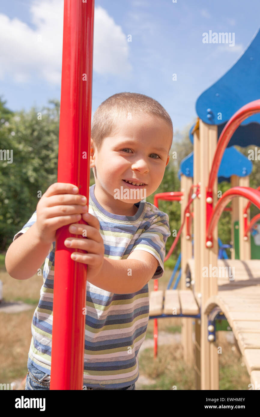 Smiling little boy on playground in summer Stock Photo