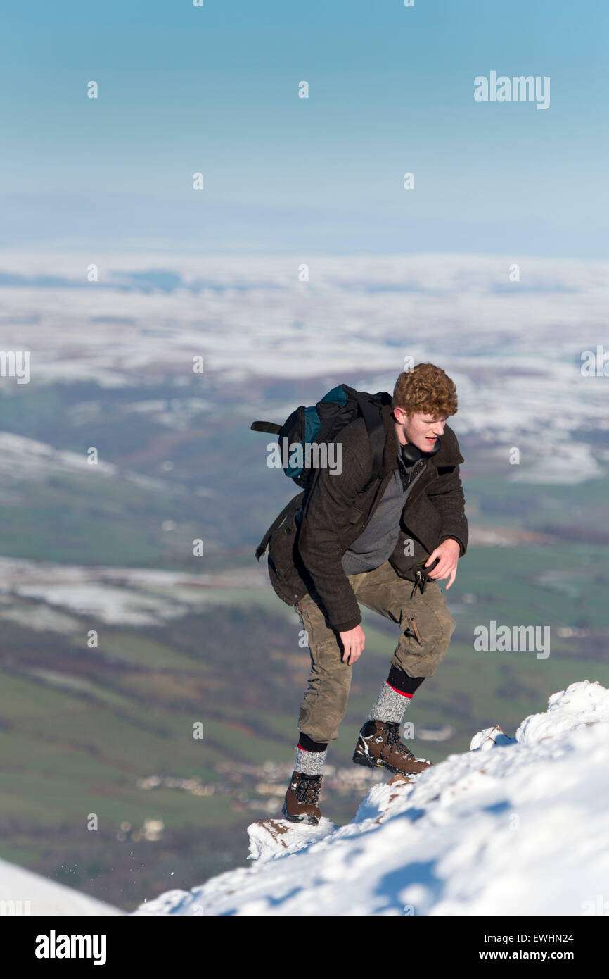 Walkers and climbers in the snow at the summit of Pen y Fan, Brecon, South Wales. Stock Photo