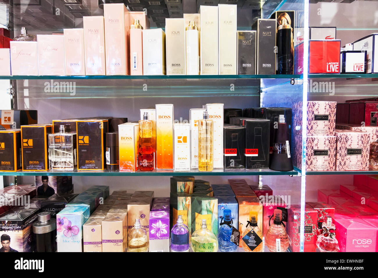 Perfumes aftershave bottles shop display Hugo Boss bottles store Lacoste Jimmy Choo Stock Photo