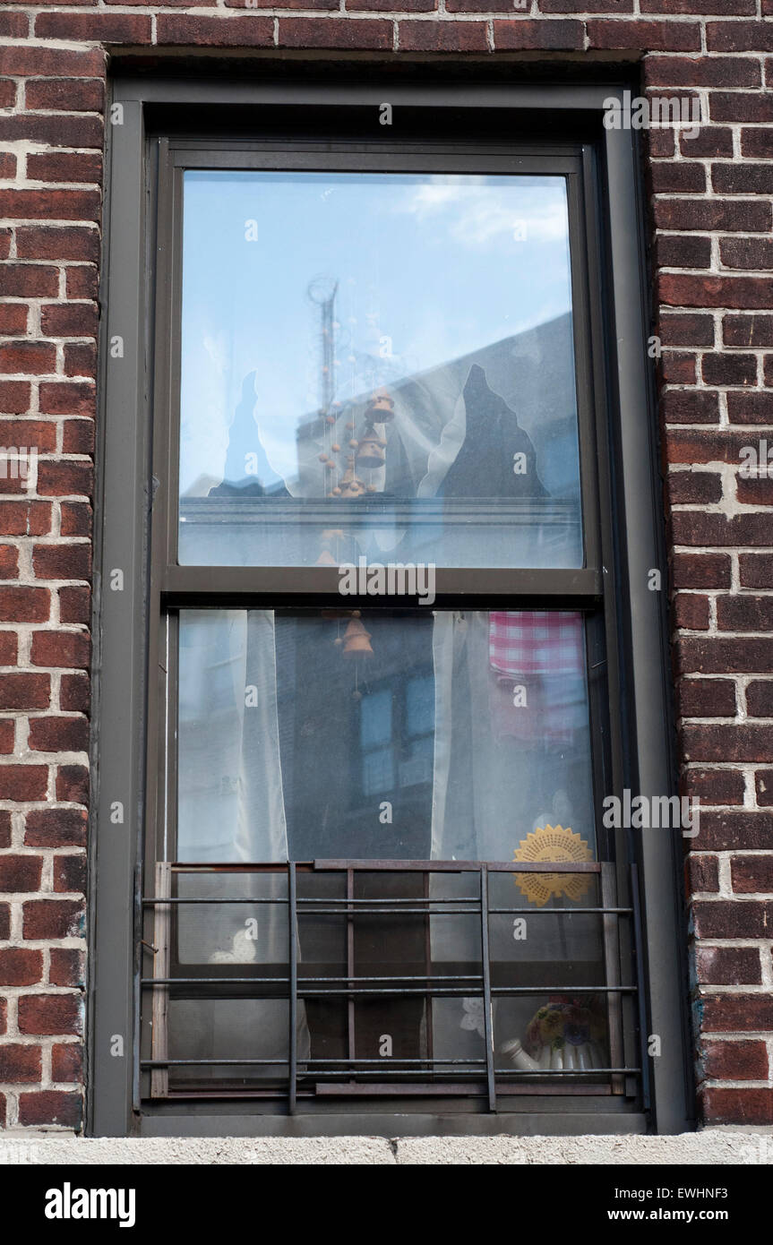 Typical windows in the buildings in the Bronx. Bronx Thinking nothing can make us imagine some friendly faces and an atmosphere Stock Photo