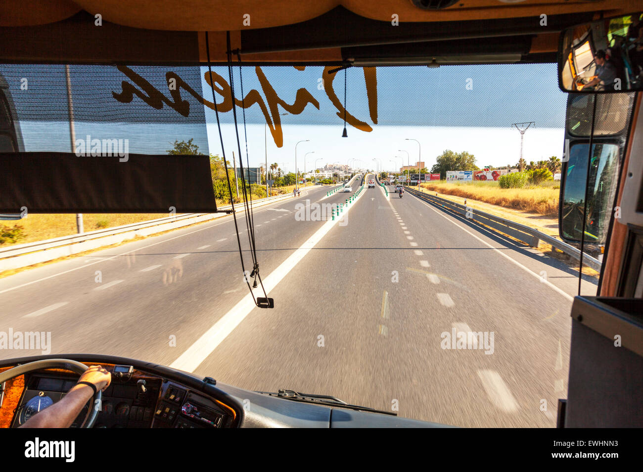 Bus driver driving buses E20 motorway Ibiza Spain road roads travelling Spanish resort Stock Photo