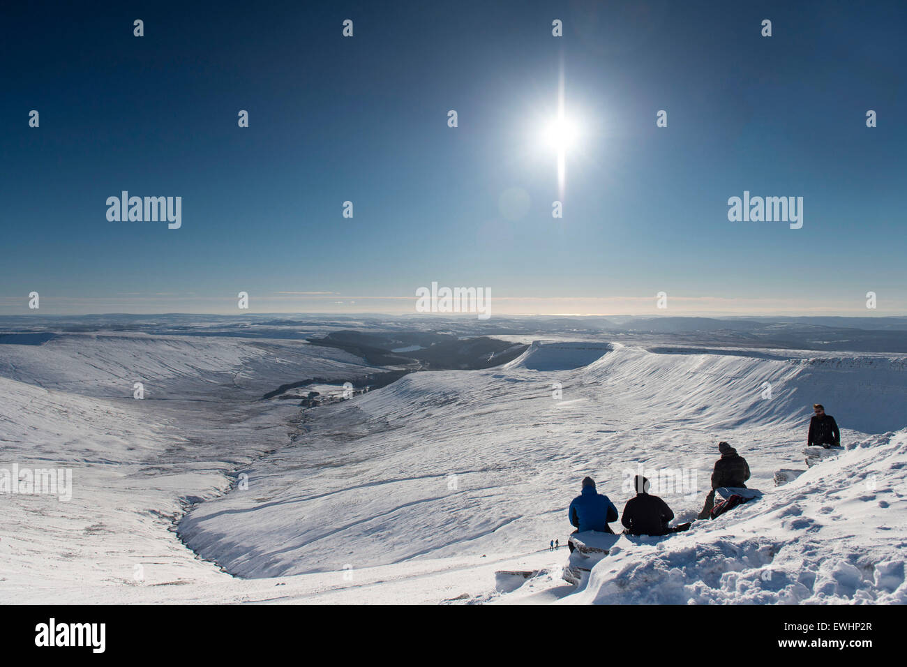 Walkers and climbers in the snow at the summit of Pen y Fan, Brecon, South Wales. Stock Photo