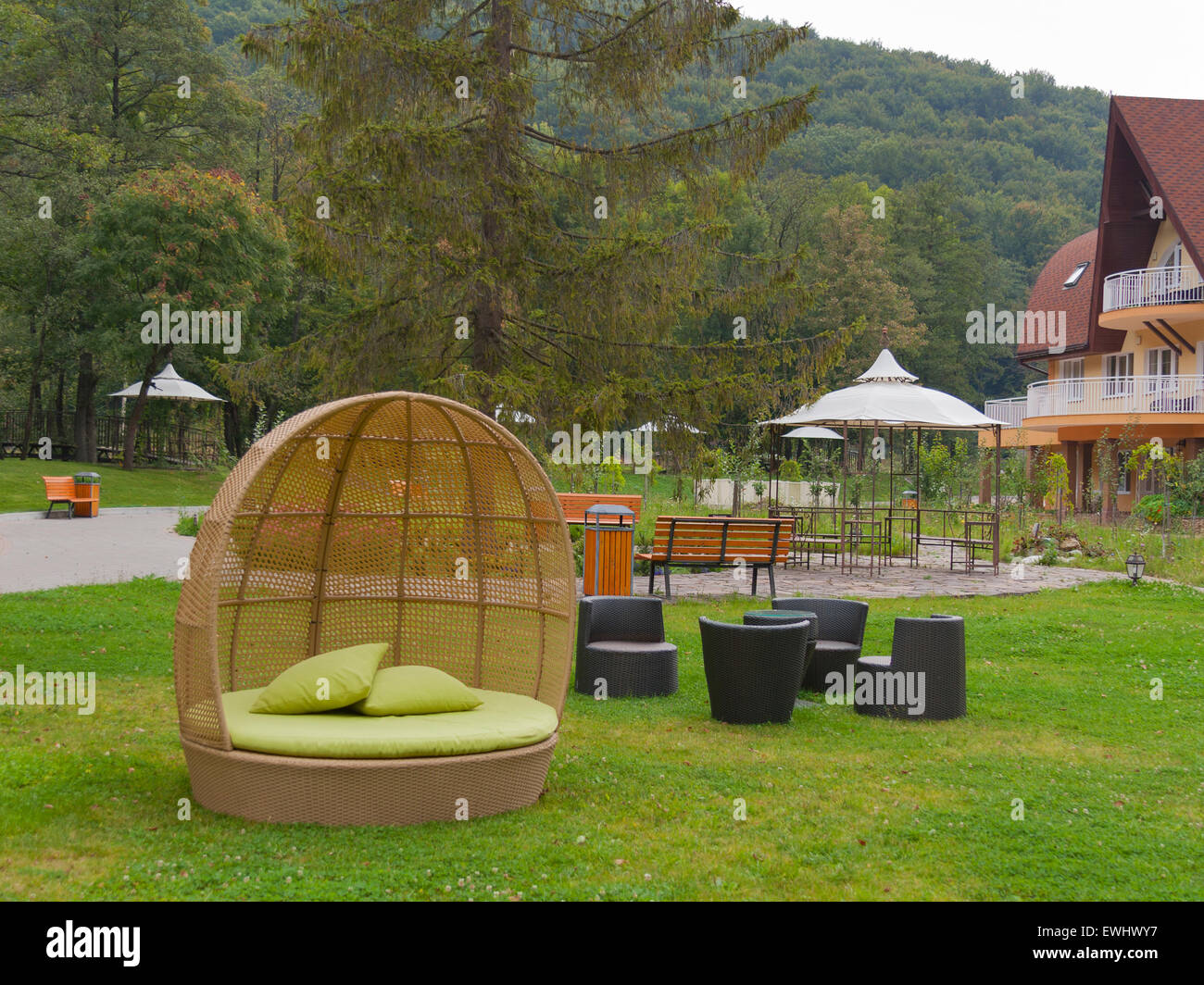 Half round modern furniture rattan wicker sofa in garden Stock Photo