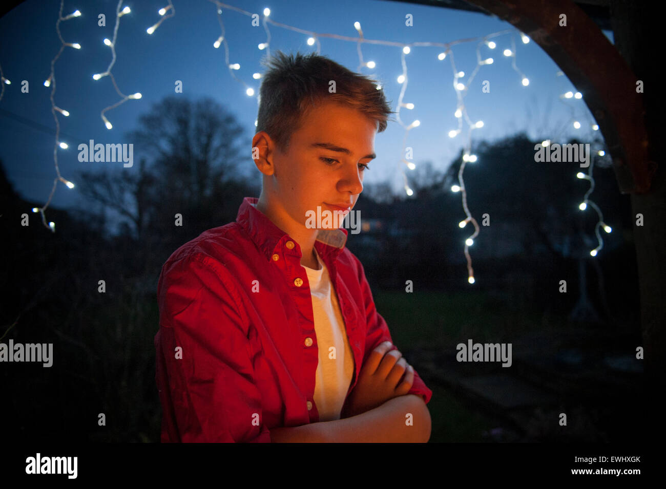 A boy considers Christmas on Christmas day at dusk Stock Photo