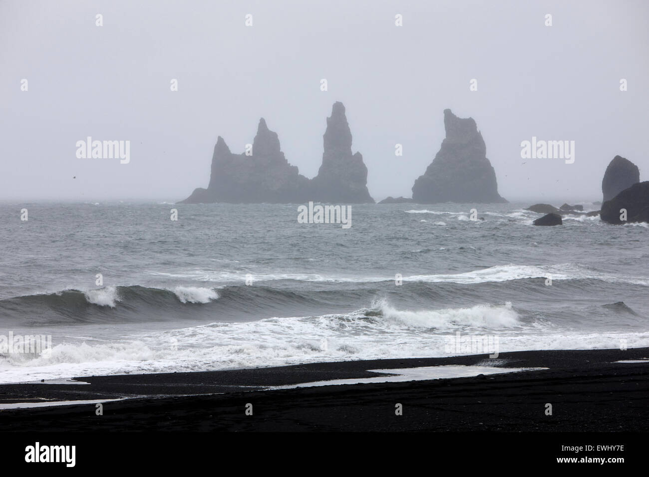mist rolling in on black sand vik beach and Vik i Myrdal Iceland Stock Photo