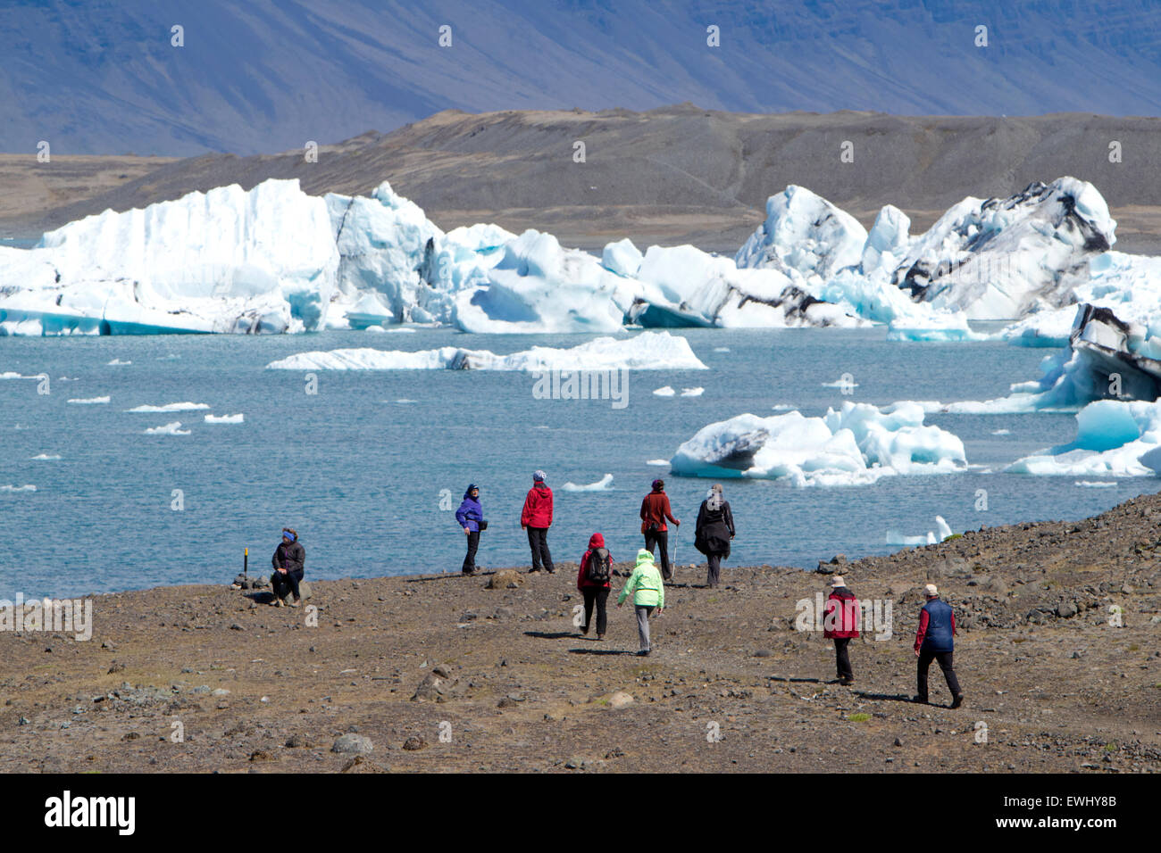 middle aged tourists walking group at Jokulsarlon glacial lagoon Iceland Stock Photo