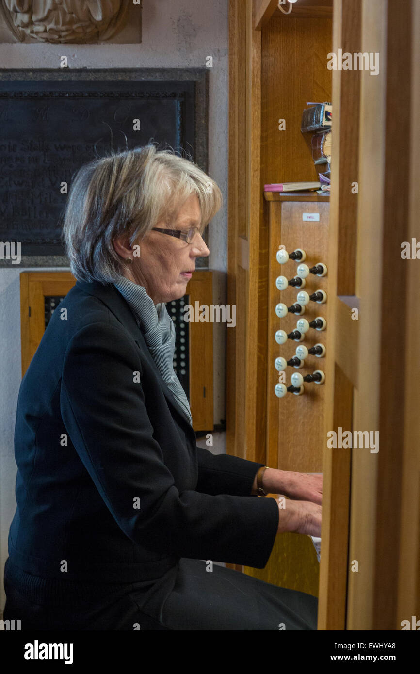 A lady plays the organ in church Stock Photo