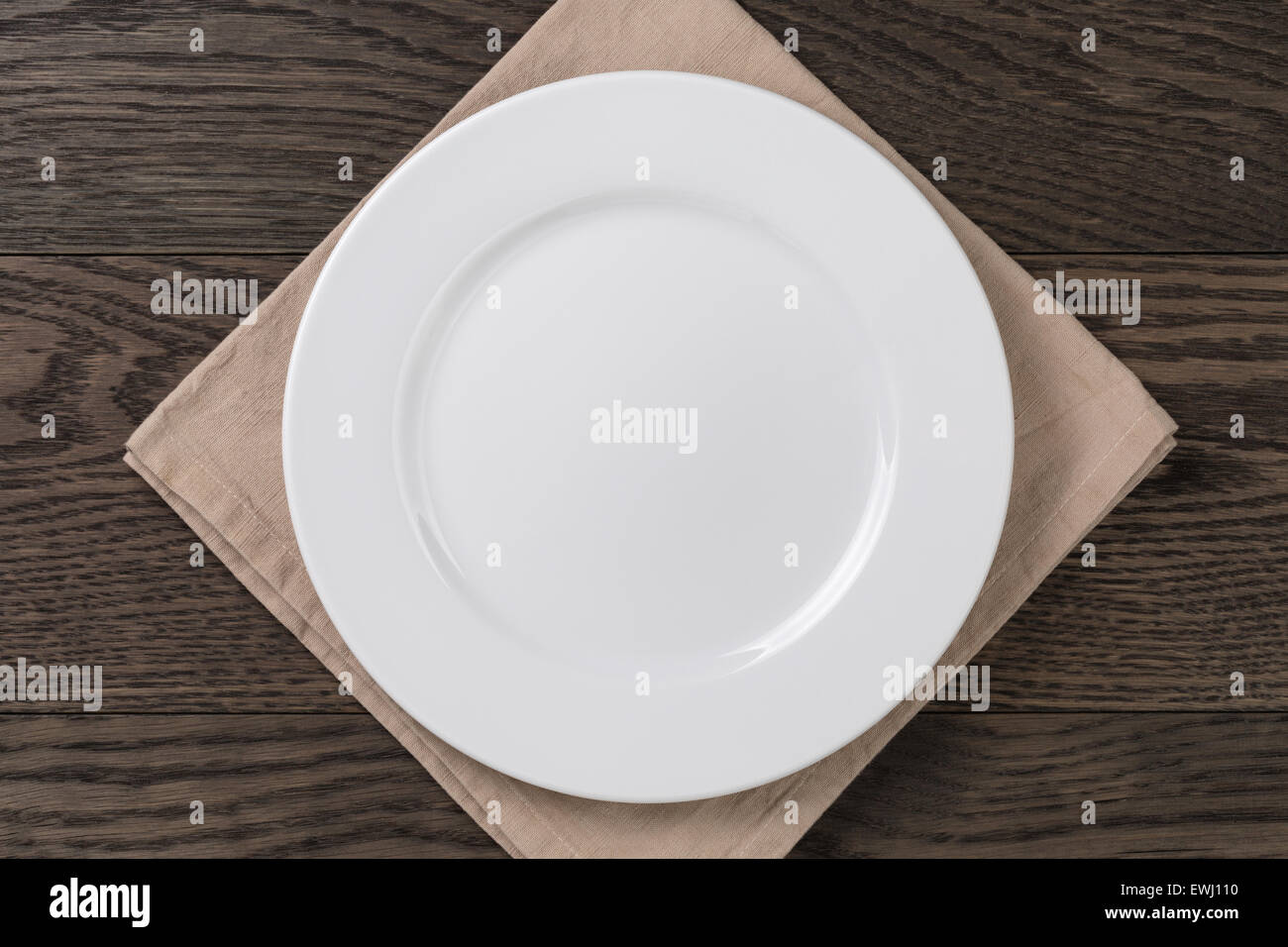 empty white plate on wood table with napkin Stock Photo Alamy