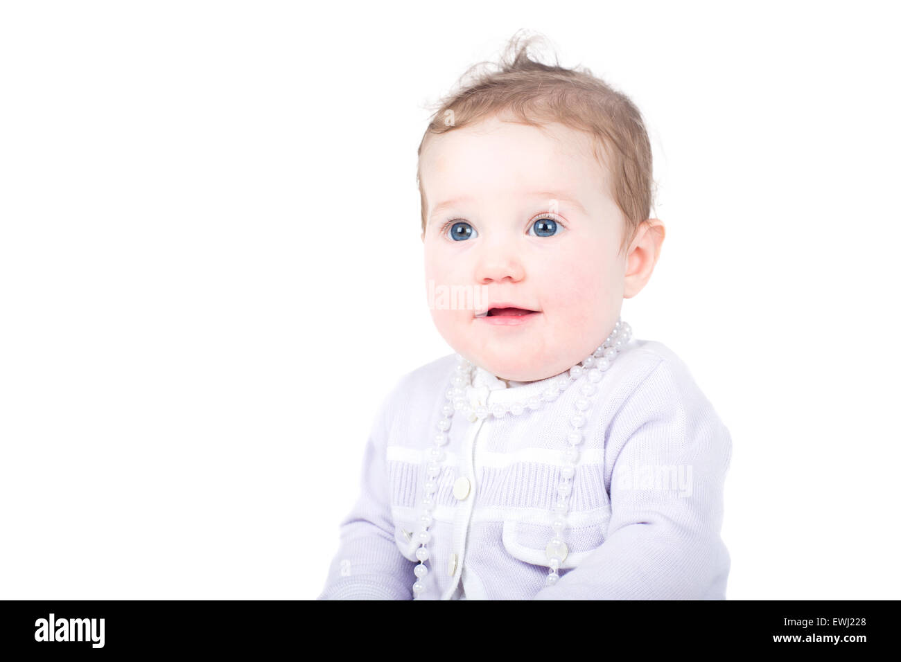 Beautiful baby girl in a purple cardigan with a pearl necklace