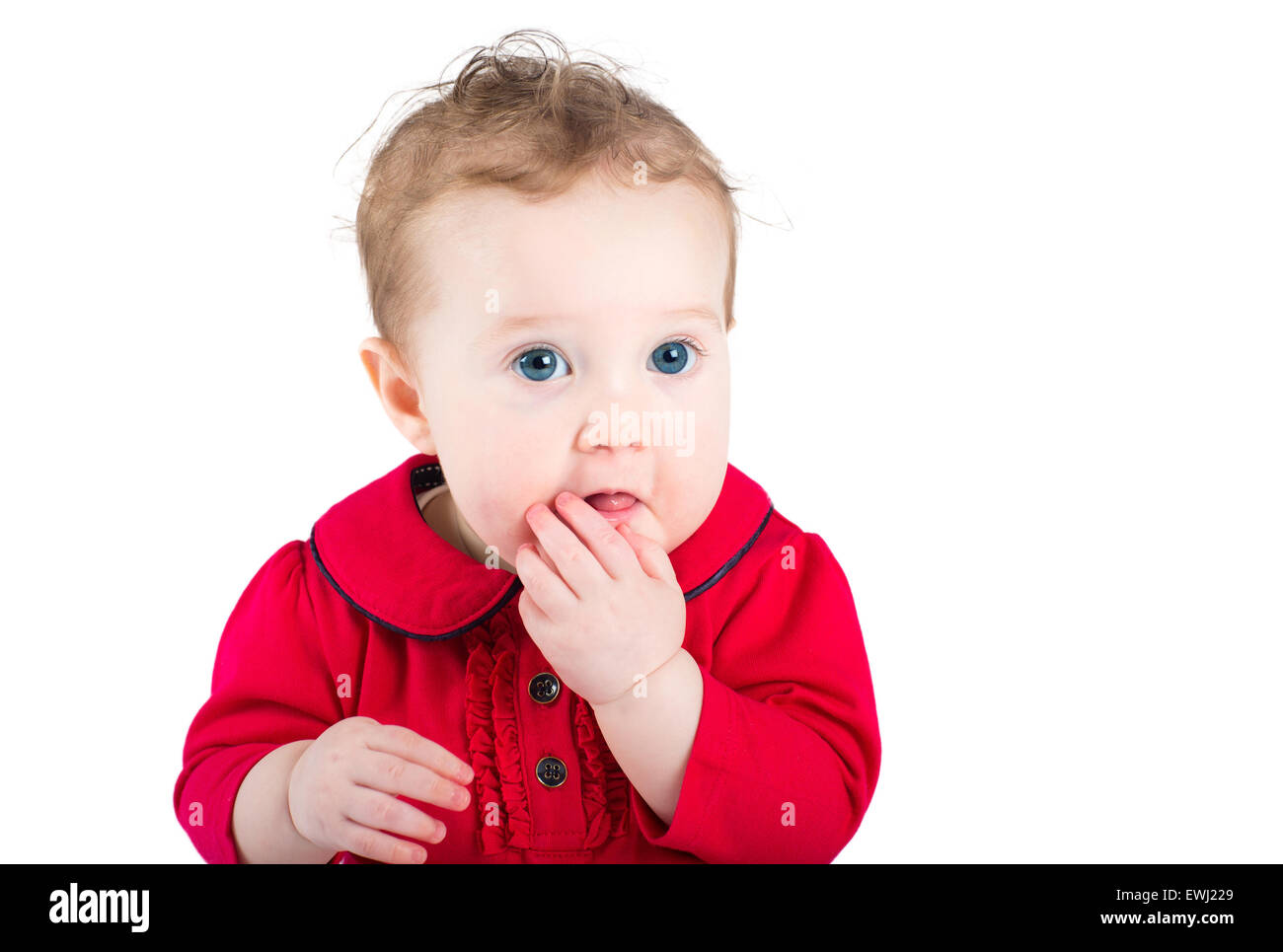 Close up portrait of a beautiful baby girl with big blue eyes wearing a red dress, isolated on white Stock Photo