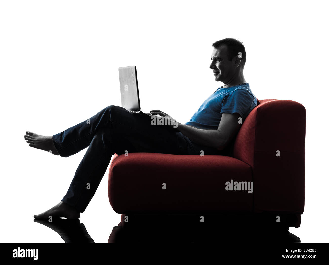 Man sitting couch smiling hi-res stock photography and images - Alamy