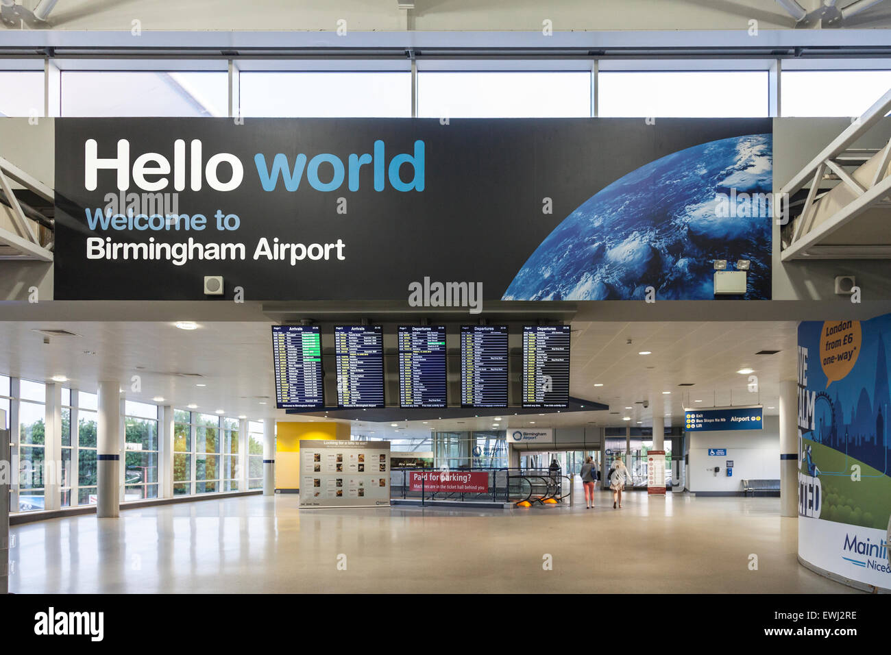 Sign: 'Hello world Welcome to Birmingham Airport'; arrivals / departures board at the Airport Rail station. Passengers; air/rail link Stock Photo