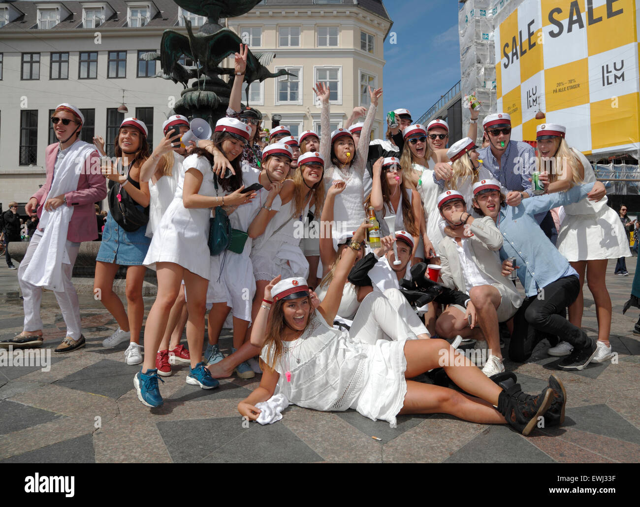Copenhagen, Denmark. June 26, 2015. Danish students celebrate their high school, grammar school graduation. A dance around and a dip or dive into the cold water of the Stork Fountain (Storkespringvandet) on the pedestrian street, Stroeget, is a traditional element on the day of celebration for  graduated students in Greater Copenhagen. It is often part of the long, exhausting and high-spirited truck tour visiting each student’s home for refreshments. Credit:  Niels Quist/Alamy Live News Stock Photo