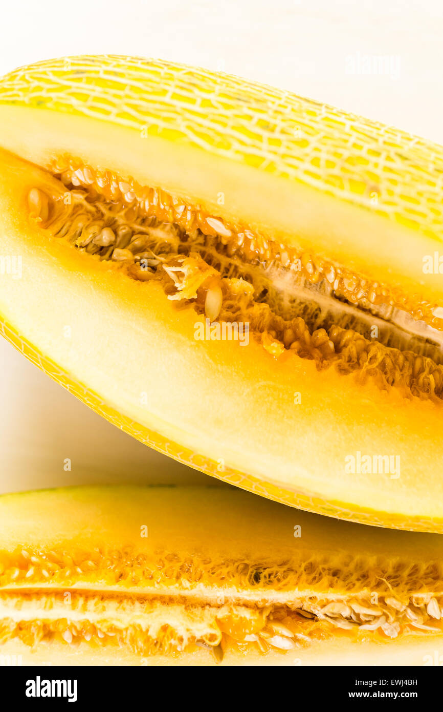 Organic Persian melon sliced on white wood board Stock Photo Alamy