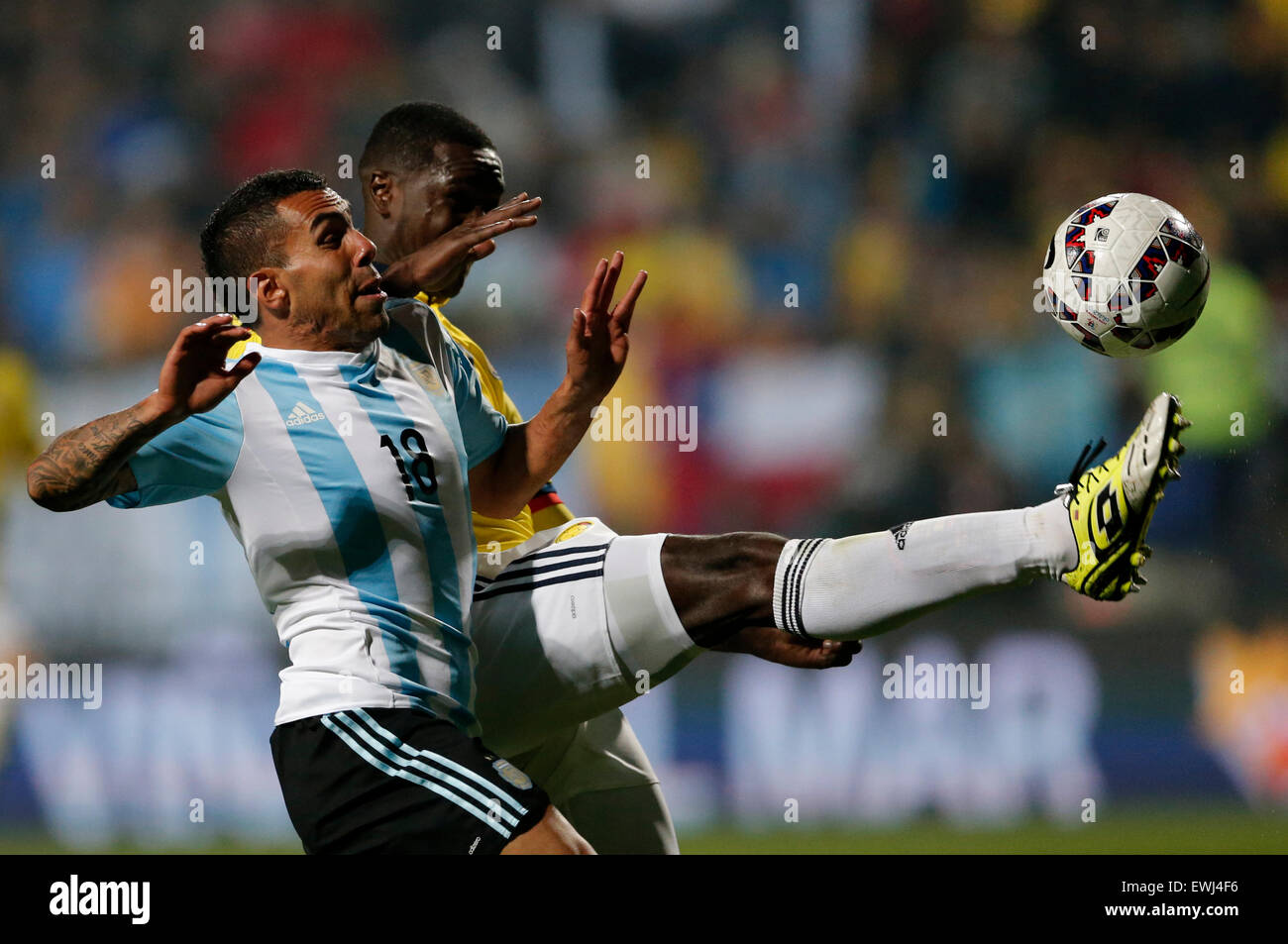 Vina Del Mar, Chile. 26th June, 2015. Argentina's Carlos Tevez (L) vies the ball with Colombia's Cristian Zapata during the quarterfinal match of the Copa America Chile 2015, held in the El Sausalito Stadium, in Vina del Mar city, Chile, on June 26, 2015. Argentina won 5-4 on penalties. Credit:  Jorge Villegas/Xinhua/Alamy Live News Stock Photo