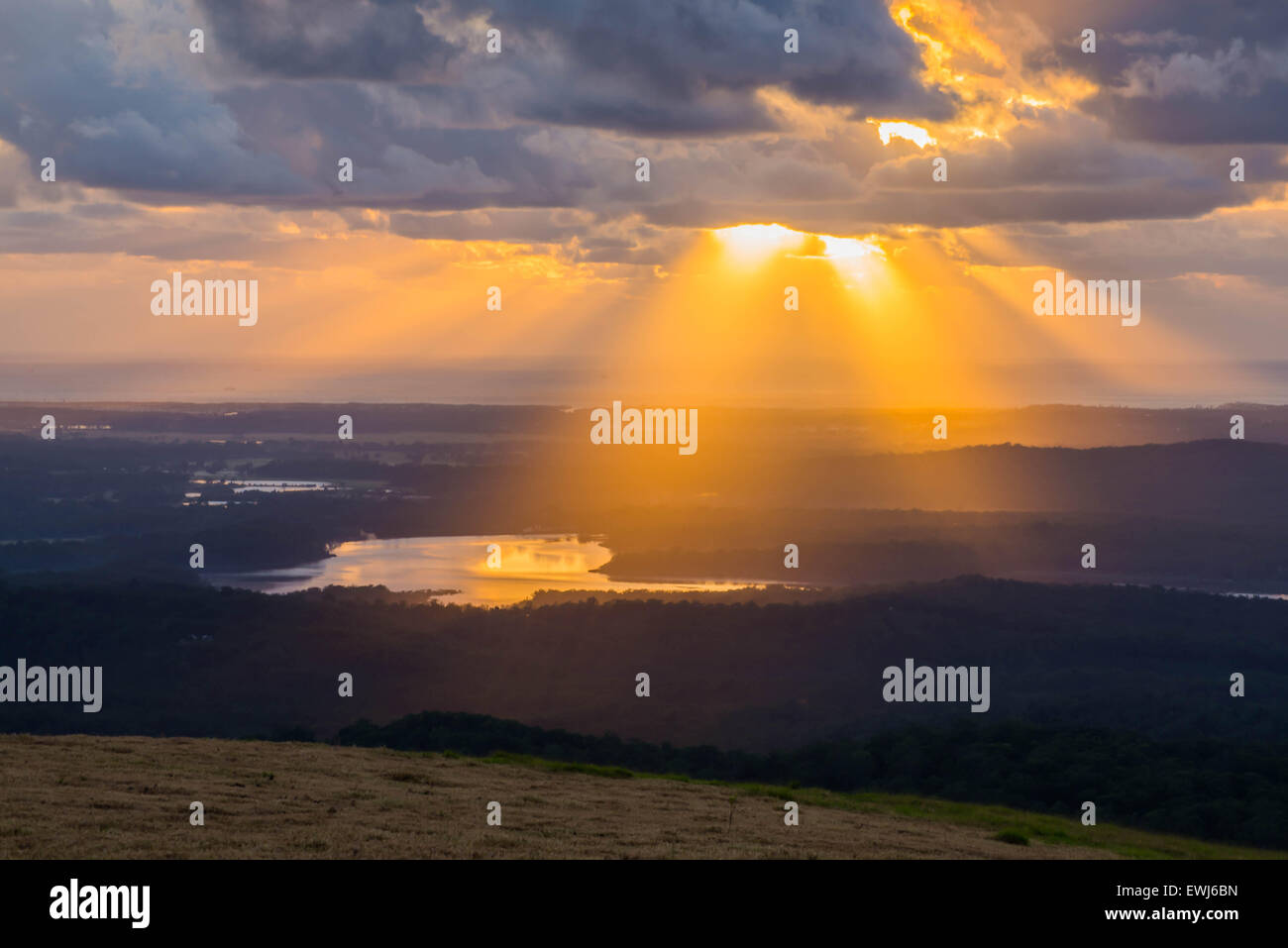 Sun Shining Through The Clouds Onto Lake At Dawn Stock Photo Alamy