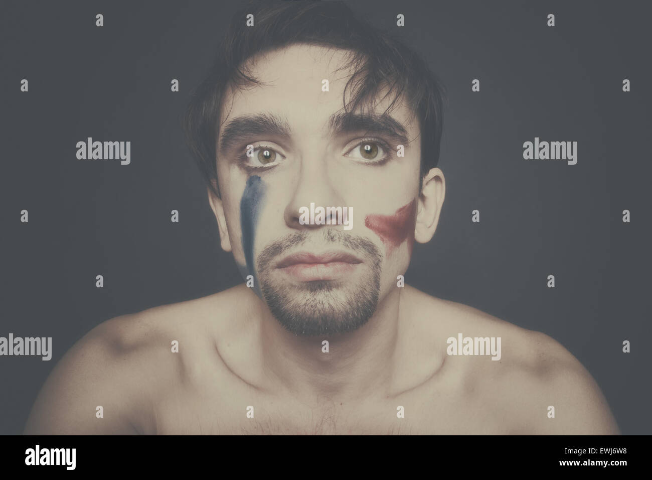 Portrait of beautiful young man with paint on his face Stock Photo - Alamy