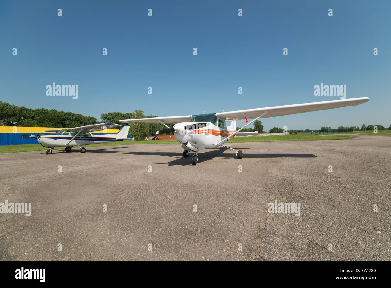 Two light planes parked on the private airfield in summer Stock Photo