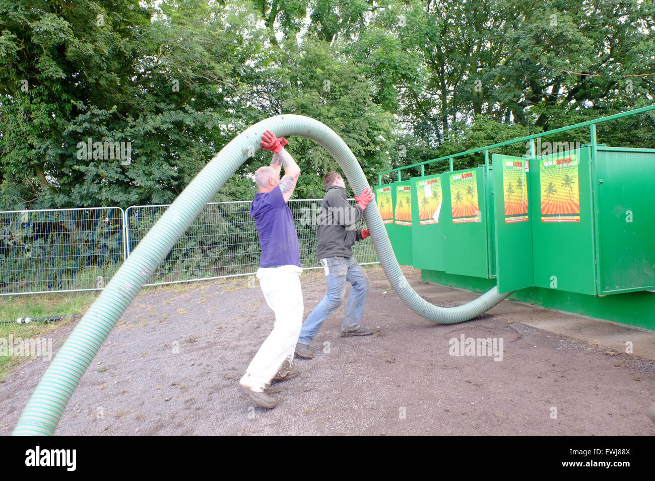 Glastonbury Festival, Somerset, UK. 27 June 2015. Festival staff empty the notorious 'long drops' ready for another day as  the sun returns and starts to dry out the mud. Credit:  Tom Corban/Alamy Live News Stock Photo