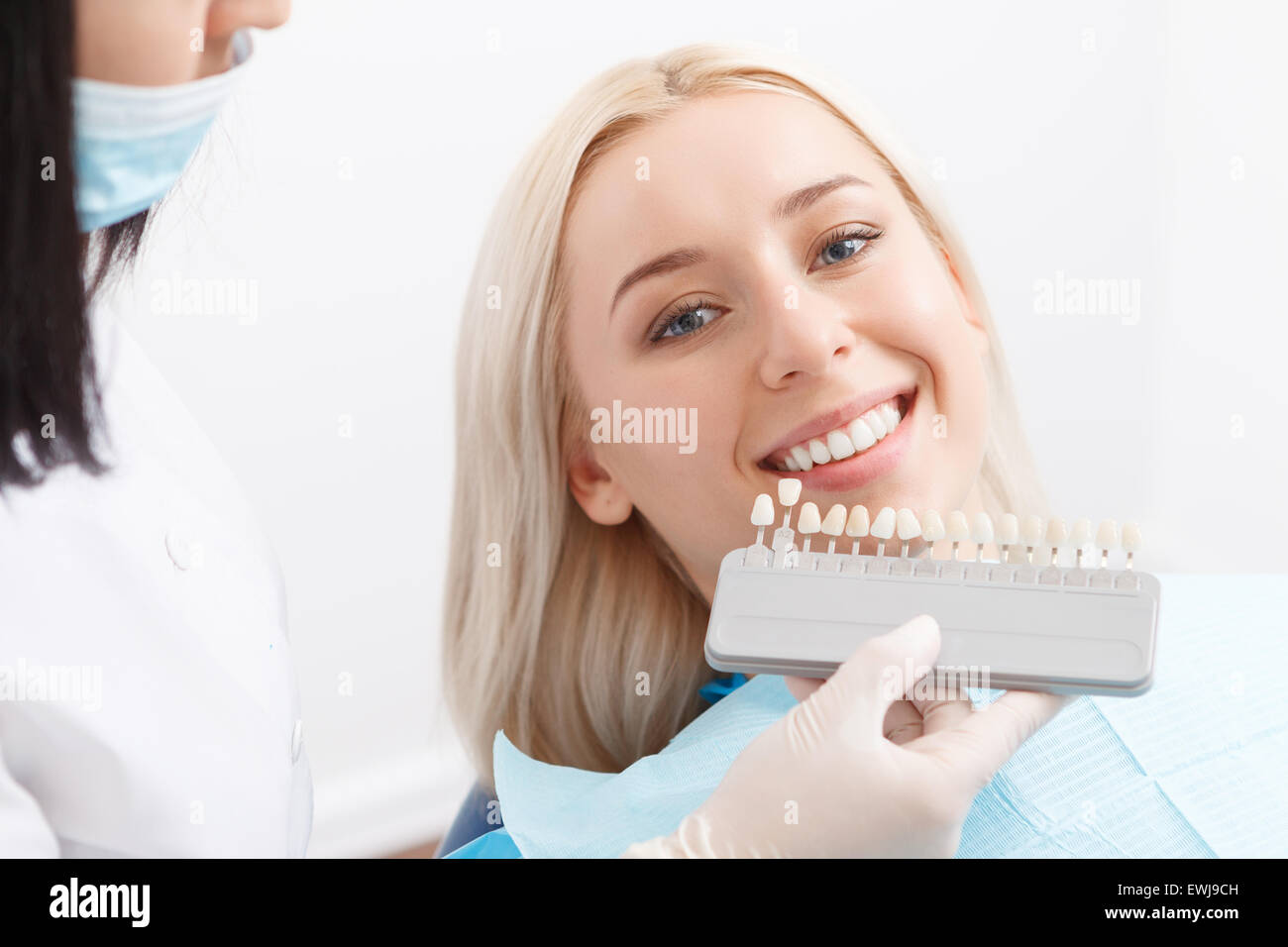 Dentist matching filling for teeth of his client Stock Photo Alamy