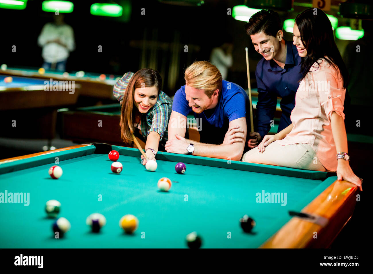 Young people playing pool Stock Photo - Alamy