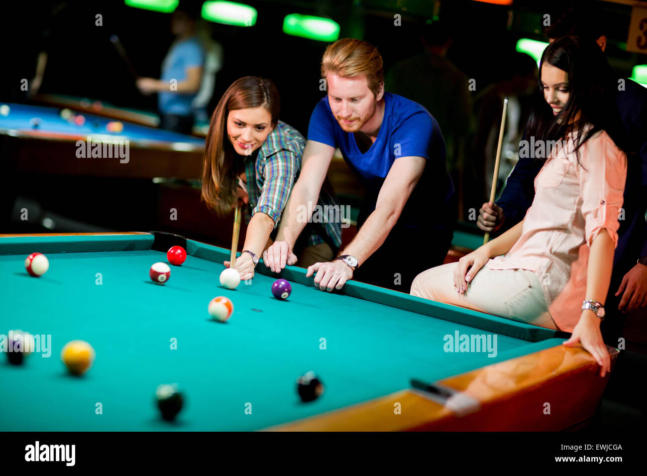 Young people playing pool Stock Photo - Alamy
