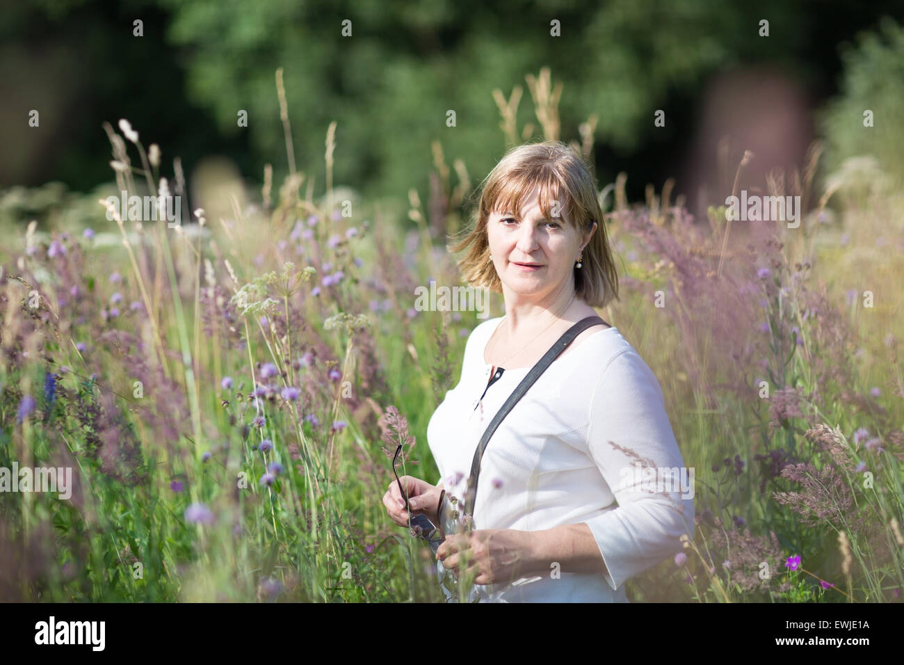 Mature woman field flowers hi-res stock photography and images - Alamy