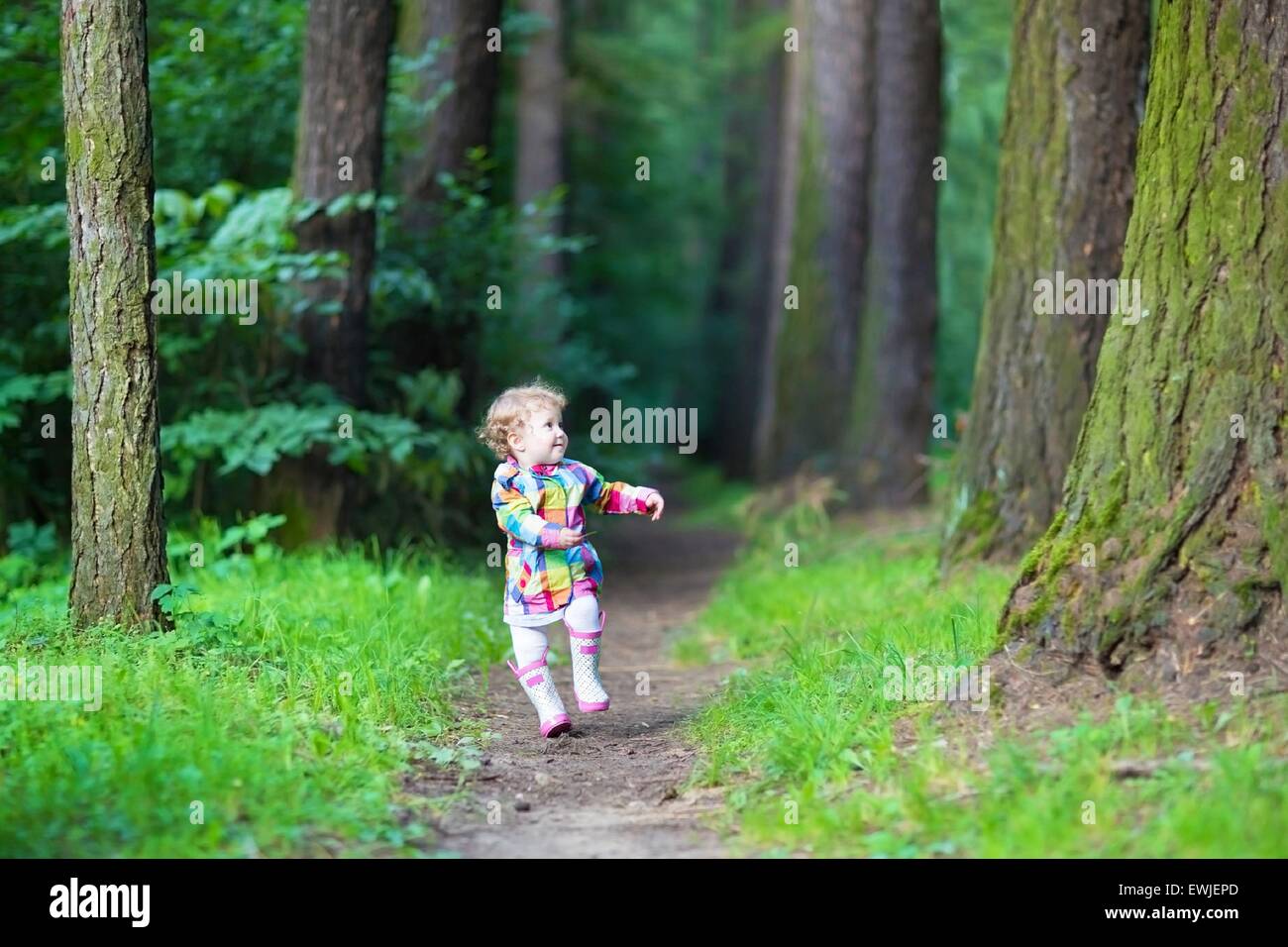 Adorable little girl playing in an autumn park Stock Photo - Alamy