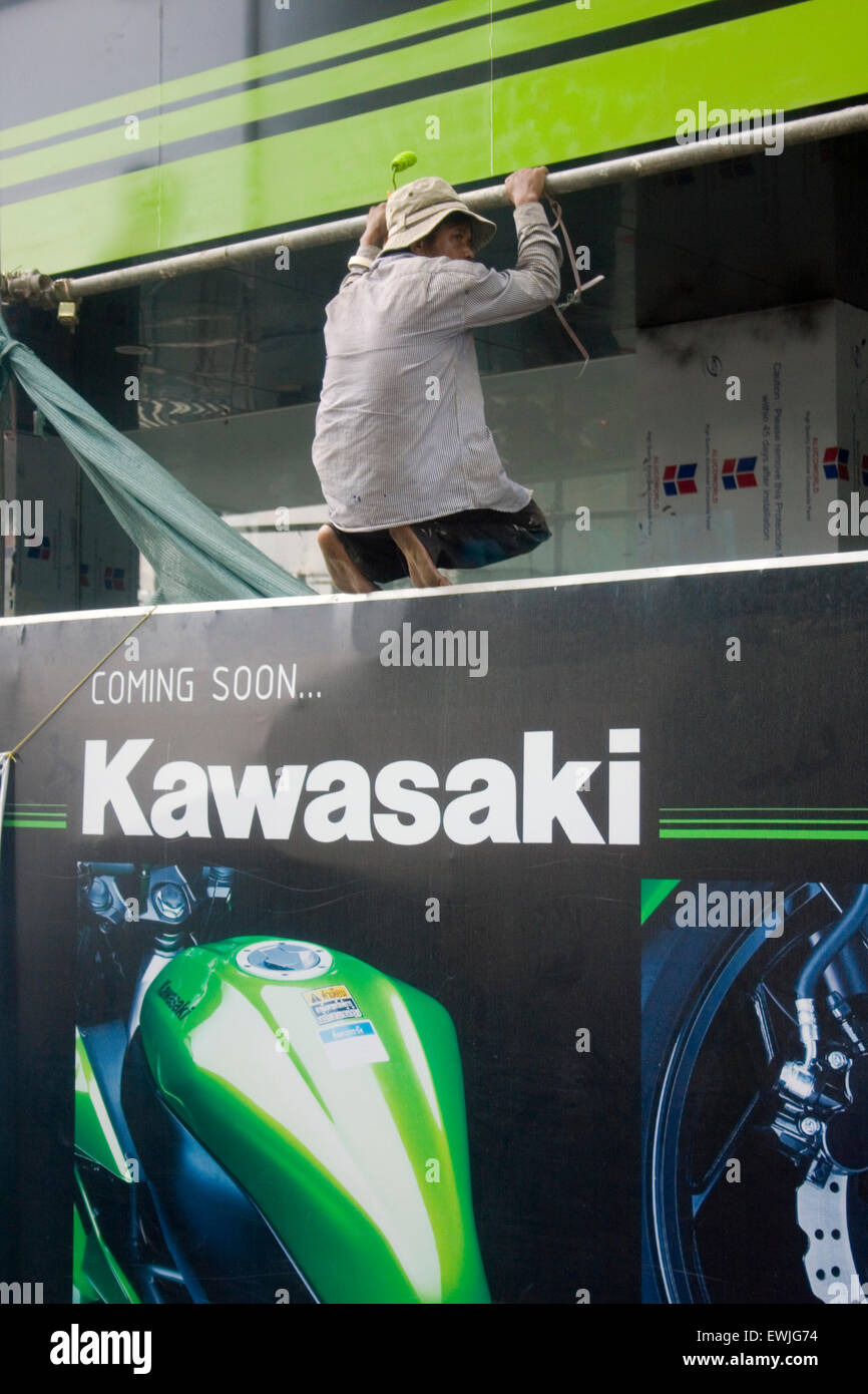 A man is working to build a new Kawasaki motorcycle showroom above a