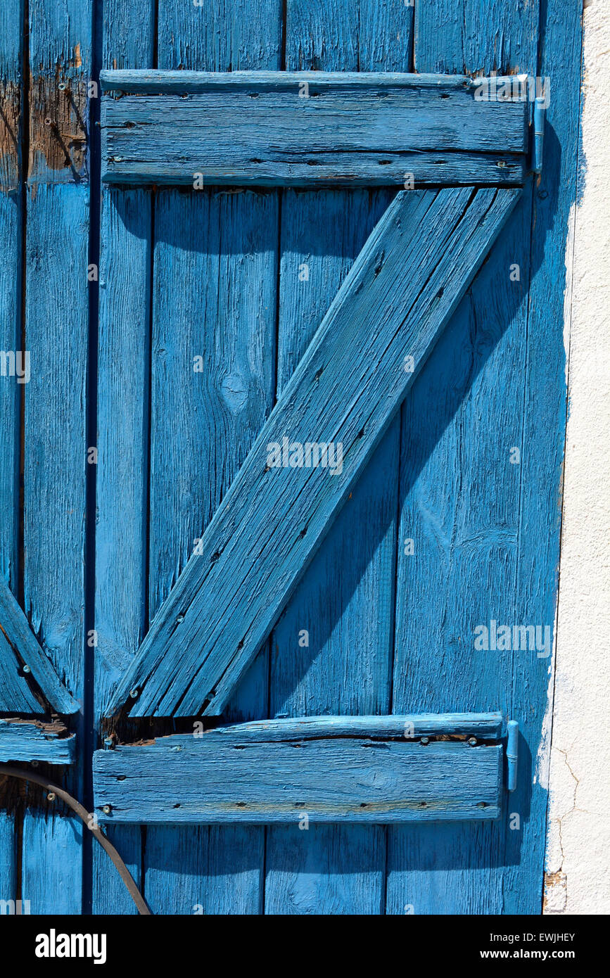 A blue painted wooden door with reinforcements in the shape of the letter Z Stock Photo