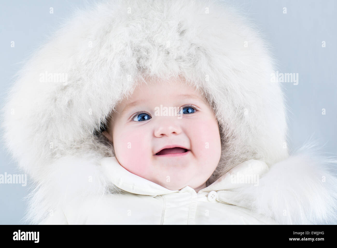 sweet baby girl wearing a big fur hat 