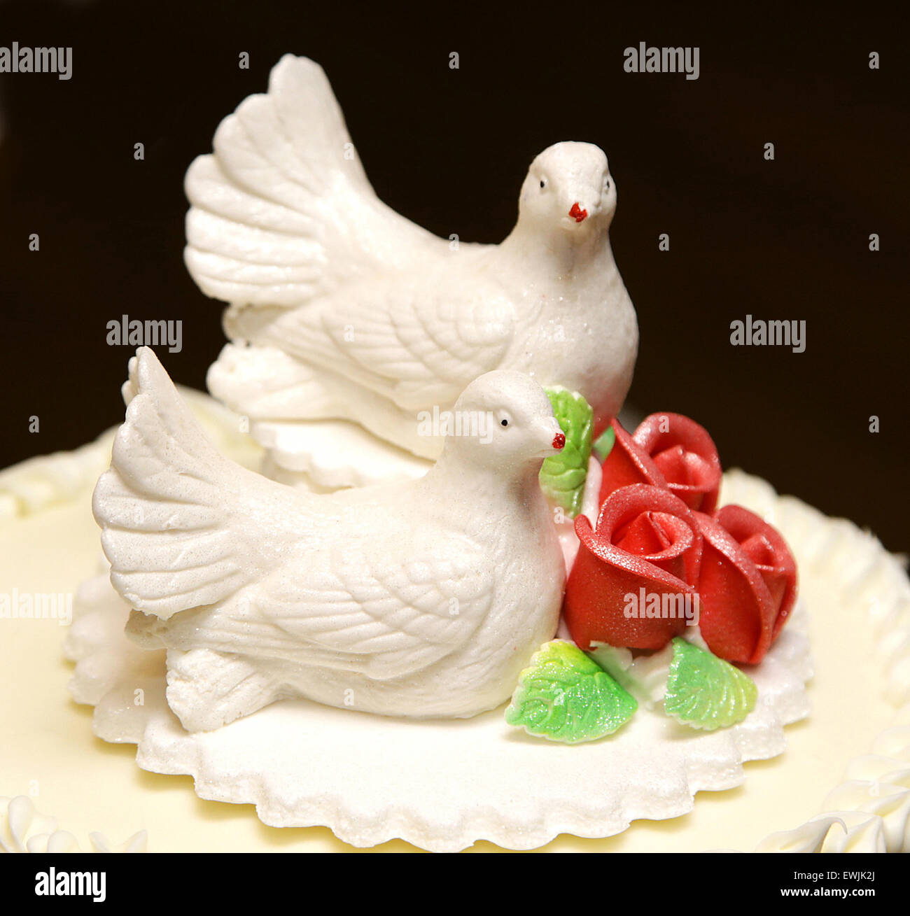 two white doves on wedding cake bride and groom isolated black