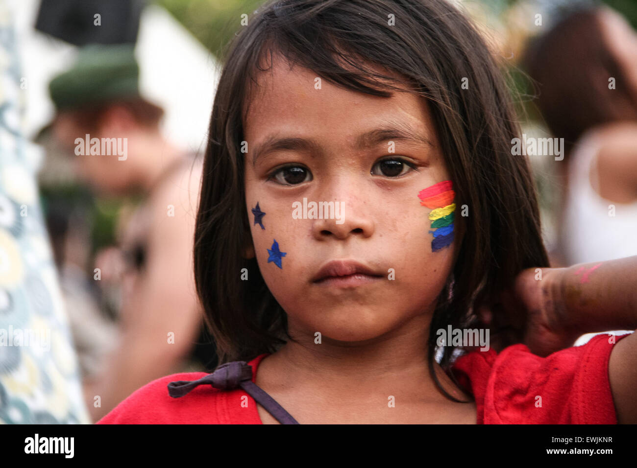 Manila, Philippines. 27th June, 2015. A young kid, with a rainbow flag face paint, poses for the camera at the Rizal Park in Manila. Thousands of LBGTQ members marched along Manila's main thoroughfare as they celebrate Manila's 21st Gay Pride Parade. Credit:  J Gerard Seguia/Pacific Press/Alamy Live News Stock Photo