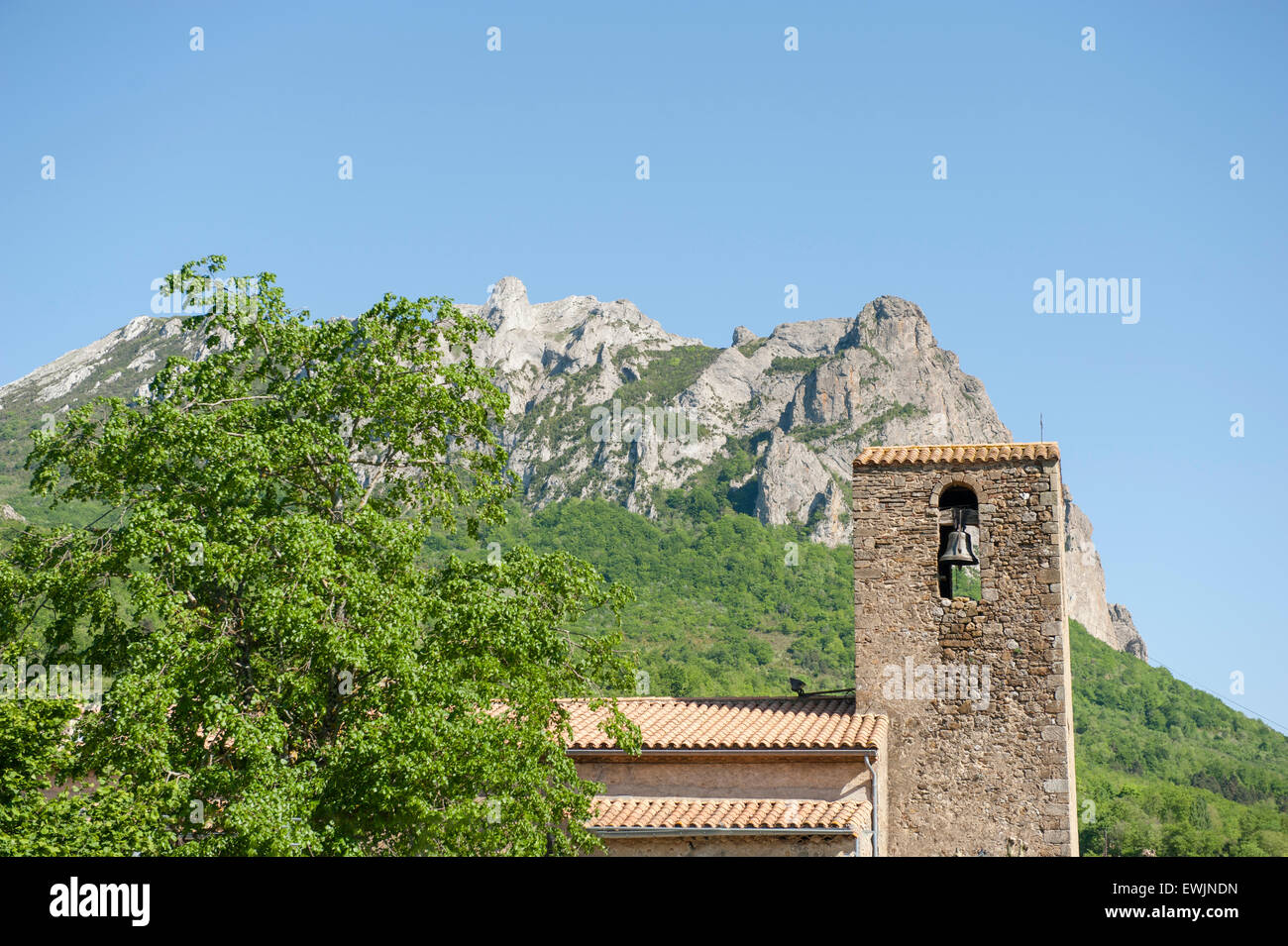 The church tower of Bugarach and the legendary Pech de Bugarach in the foothills of the Pyrenees Stock Photo