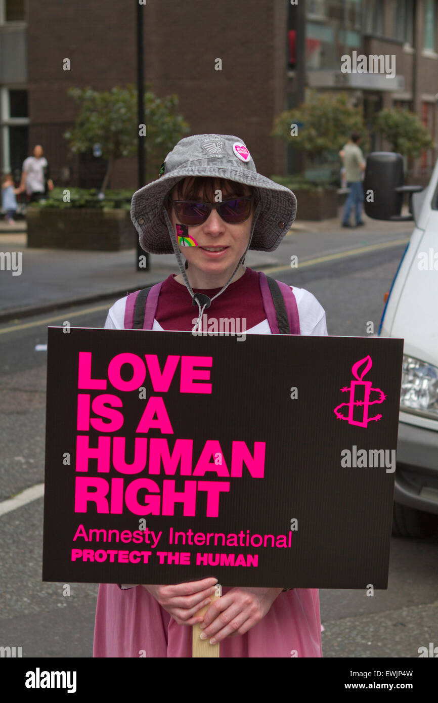 A woman holding a placard supporting Human Rights and Amnesty International London's Gay Pride parade Stock Photo