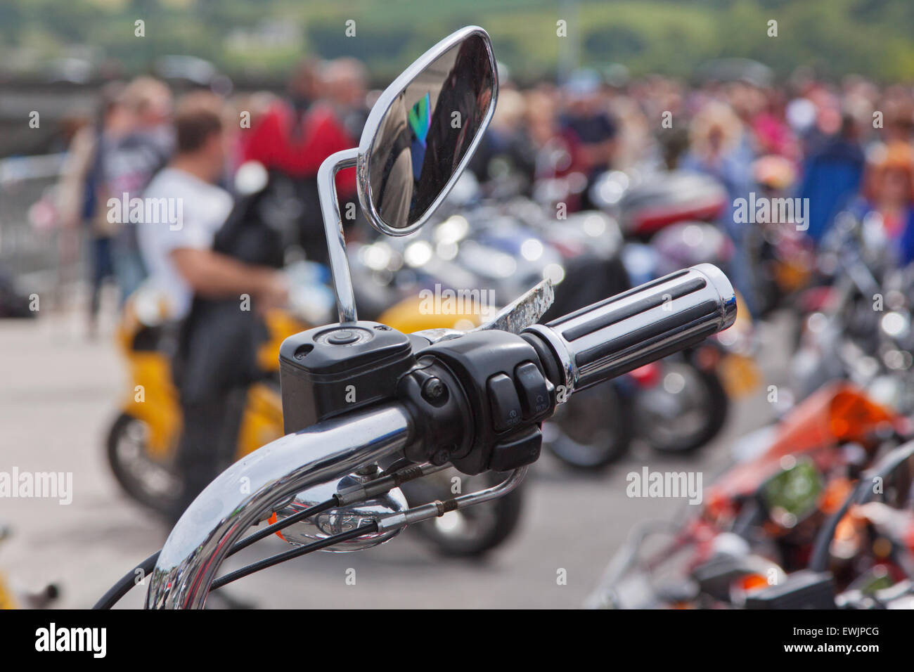 One of the wing mirrors and hand controls of a parked motorcycle at a bike rally in UK Stock Photo