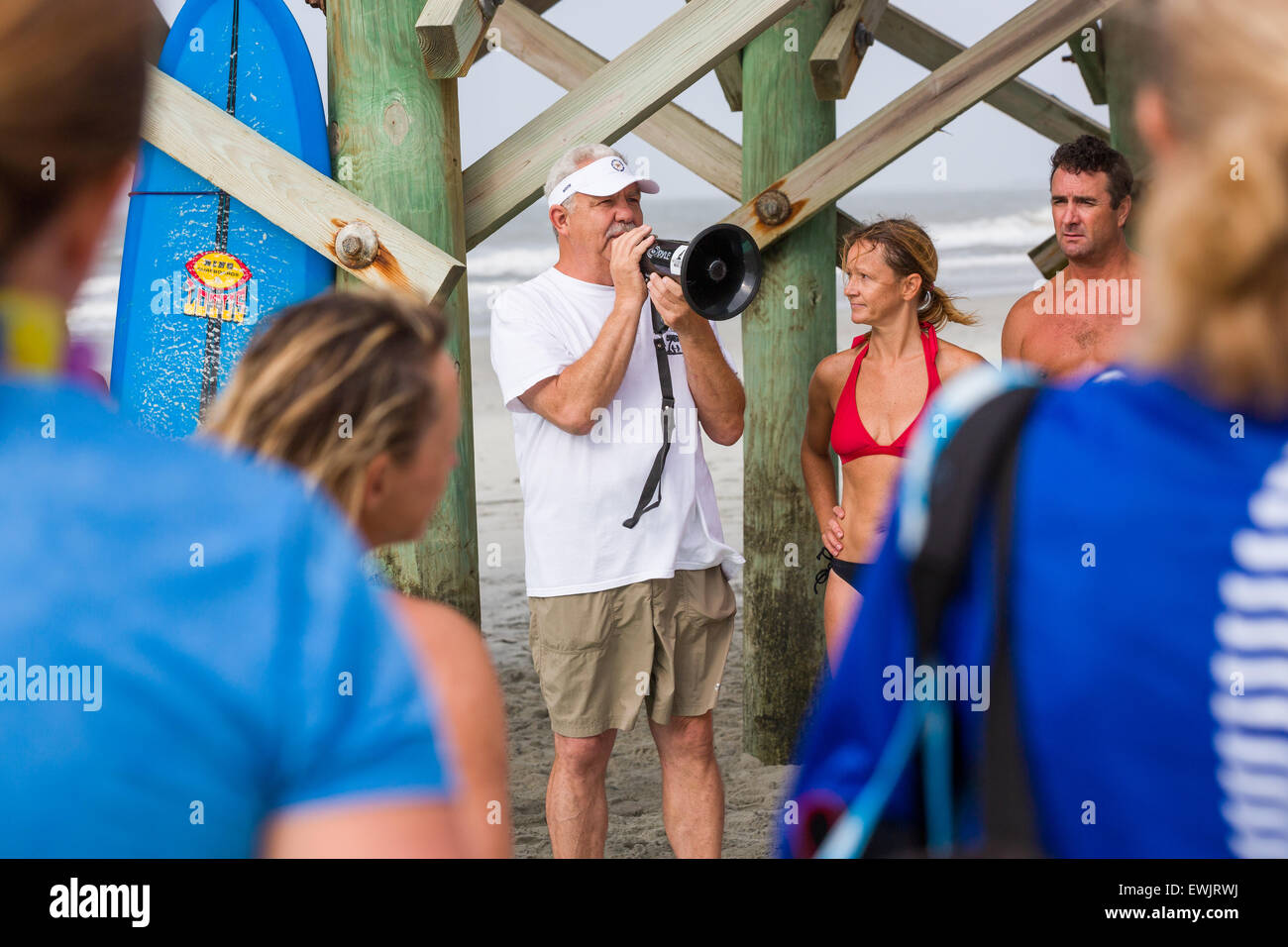 Folly beach, South Carolina, USA. 27th June, 2015. Folly Beach Mayor Tim Goodwin addresses surfers gathered for a traditional memorial paddle out to honor and remember the nine people killed at the historic mother Emanuel African Methodist Episcopal Church June 27, 2015 in Folly Beach, South Carolina. Earlier in the week a white supremacist gunman killed 9 members at the historically black church. Stock Photo