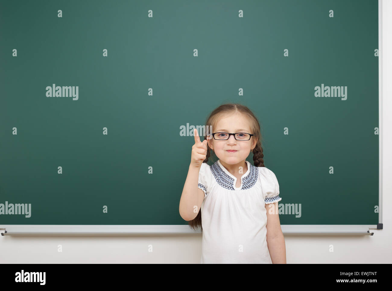 Schoolgirl near the school board Stock Photo - Alamy