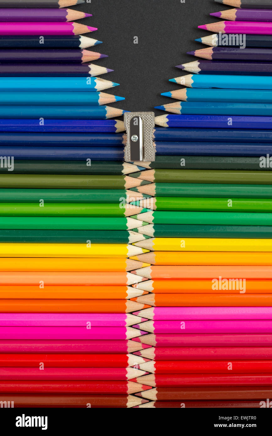 Colouring pencils arranged to look like a multi-coloured zipper Stock Photo