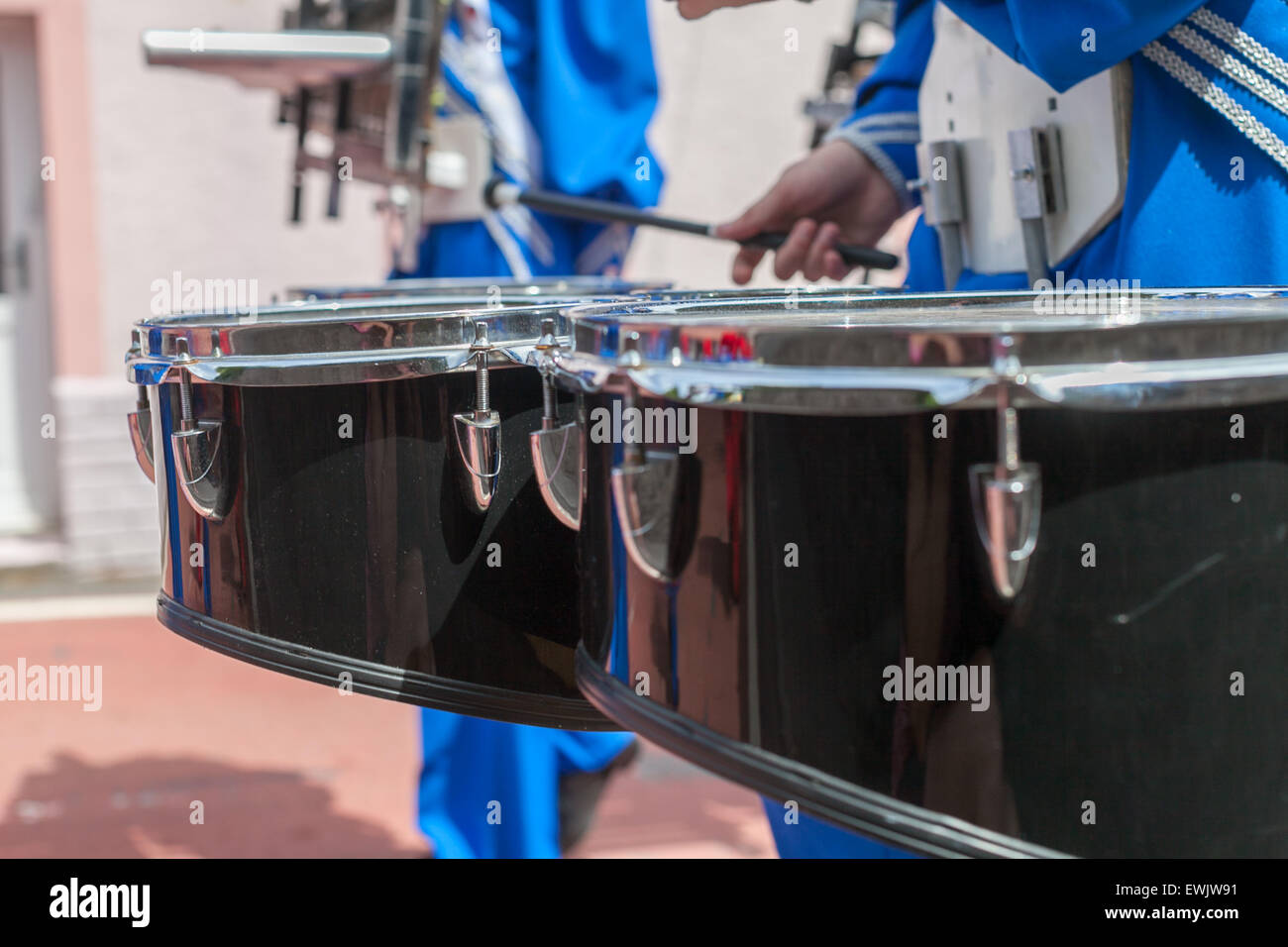Close up of a marching band drum being played at St Clears Carnival June 2015 in Pembrokeshire Wales.  Town parade. Stock Photo