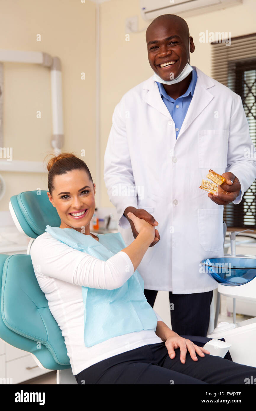 portrait of happy dentist congratulate patient for a successful operation Stock Photo