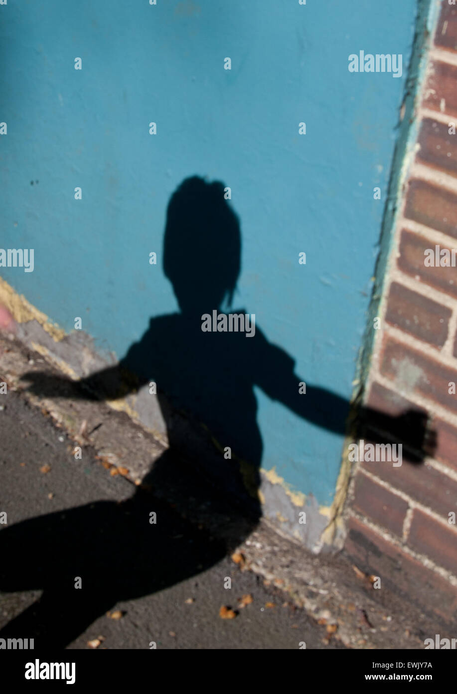 boy's shadow on wall Stock Photo