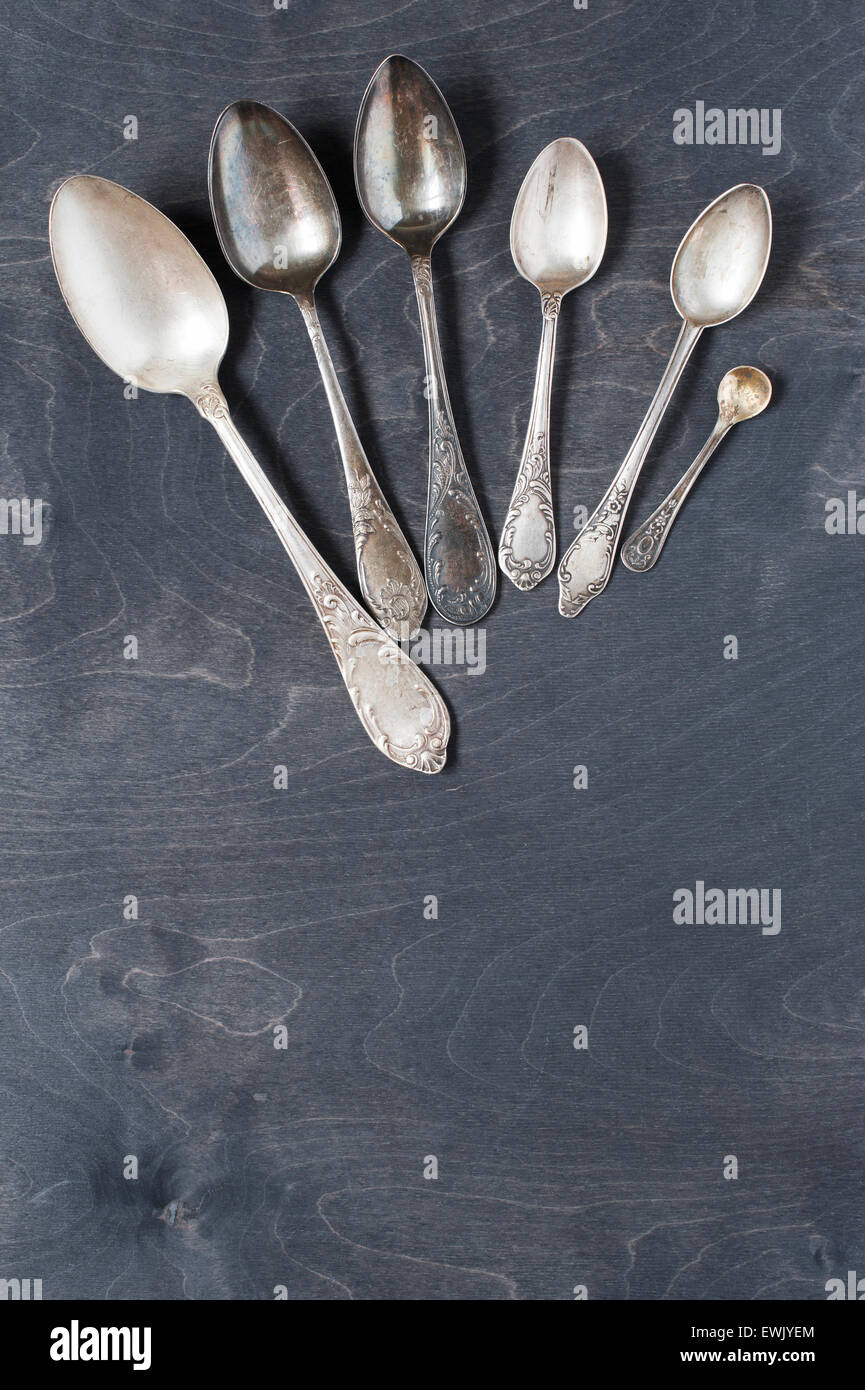 Vintage silver spoons on the dark wooden table Stock Photo
